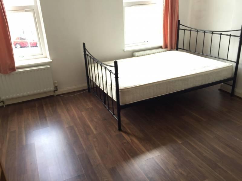Bright, simply furnished double bedroom with a ...