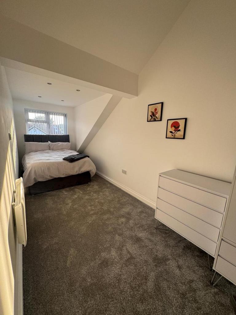 Bright, freshly decorated double bedroom with a...