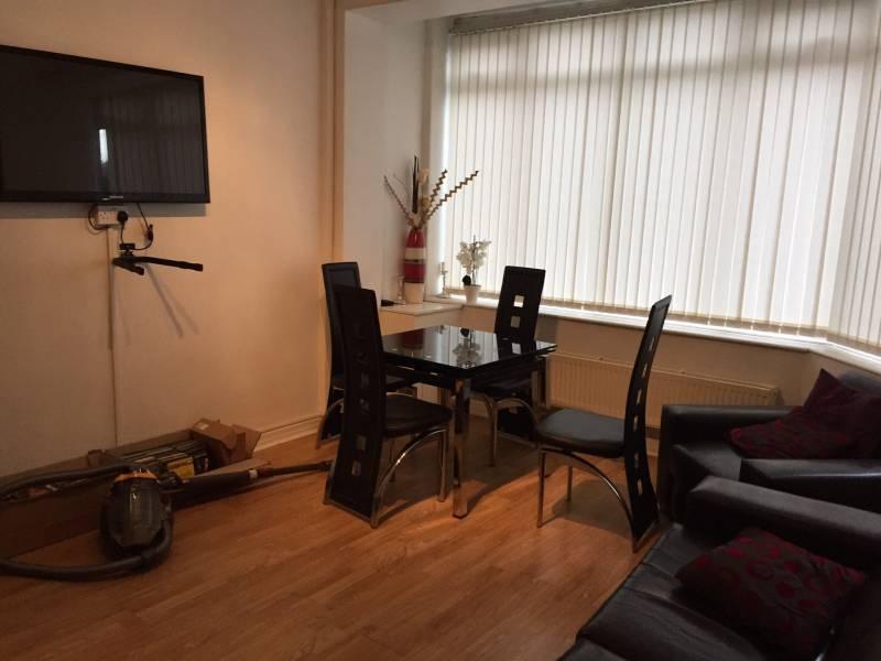 Bright living area with a large bay window, mod...