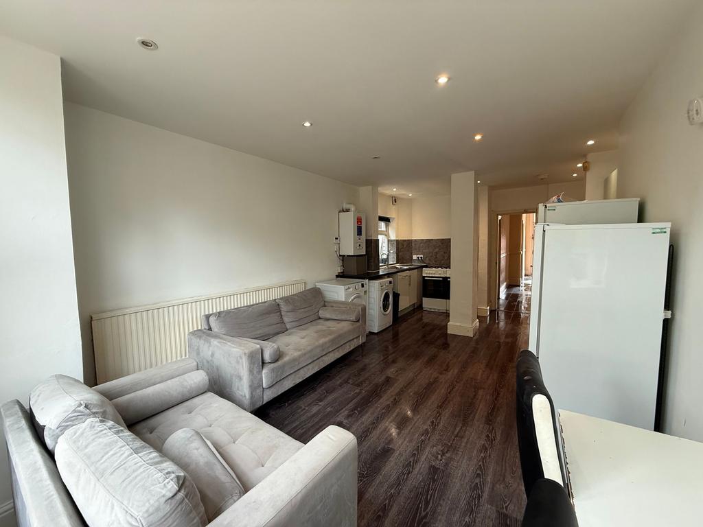 Long open-plan living area with two grey sofas,...