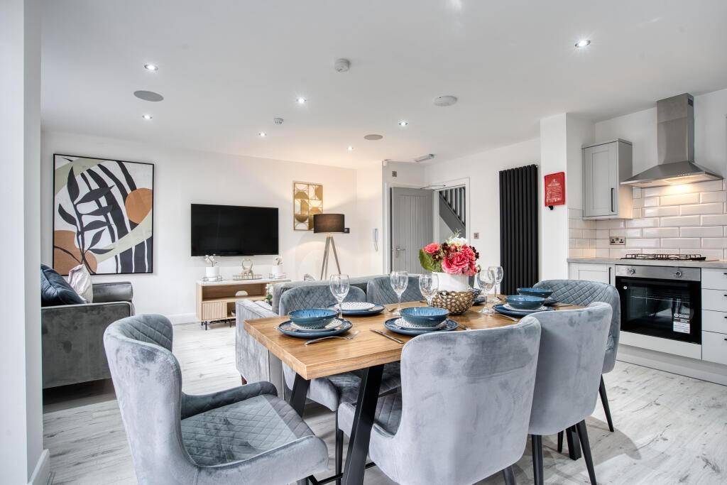 A modern, well-lit living room featuring contem...