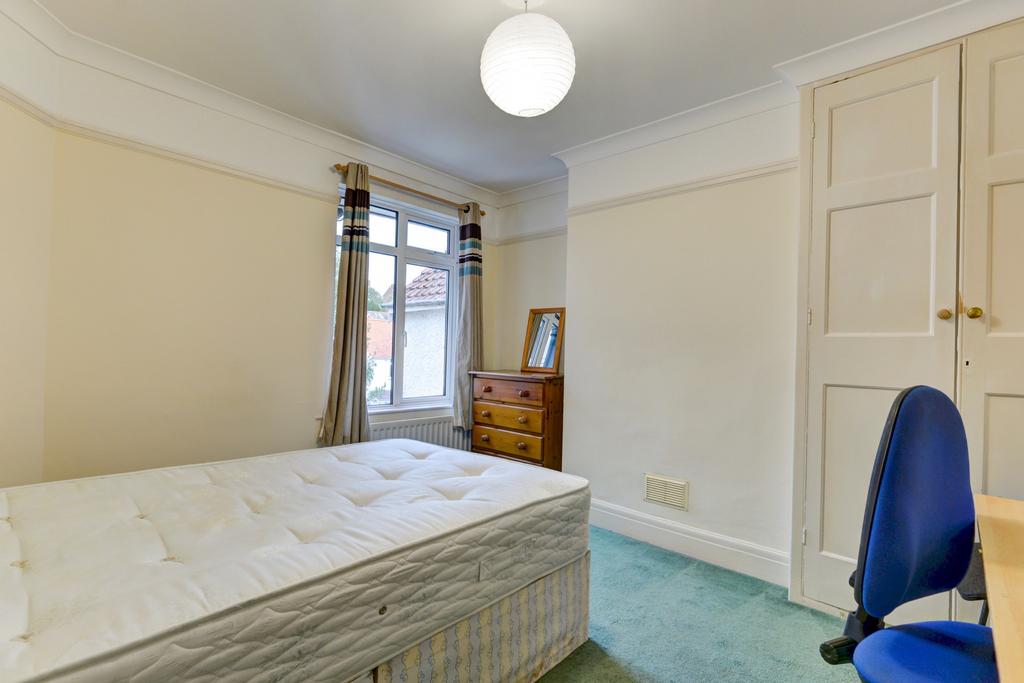 A spacious and well-maintained bedroom with a l...