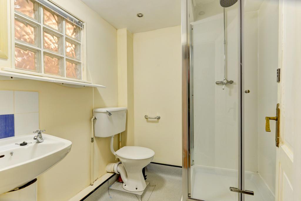 A clean and functional bathroom with a shower, ...
