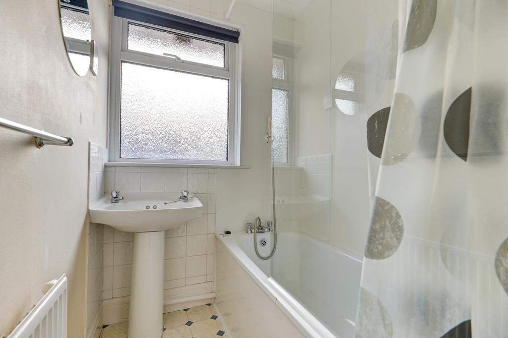 Bright and clean bathroom with a standard batht...