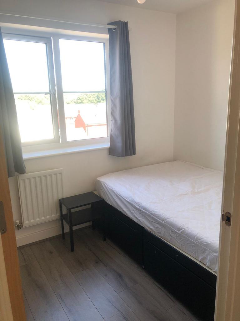 Bright, simply furnished bedroom with a large w...