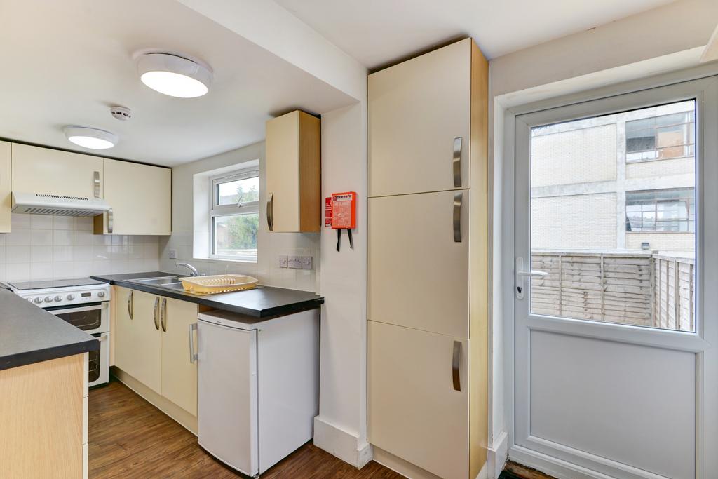 Bright, modern kitchen with fitted cabinets, in...