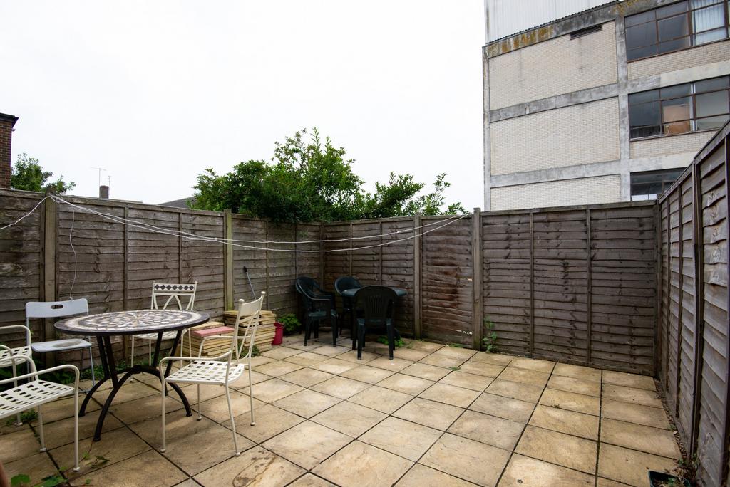 Private paved courtyard with outdoor dining set...