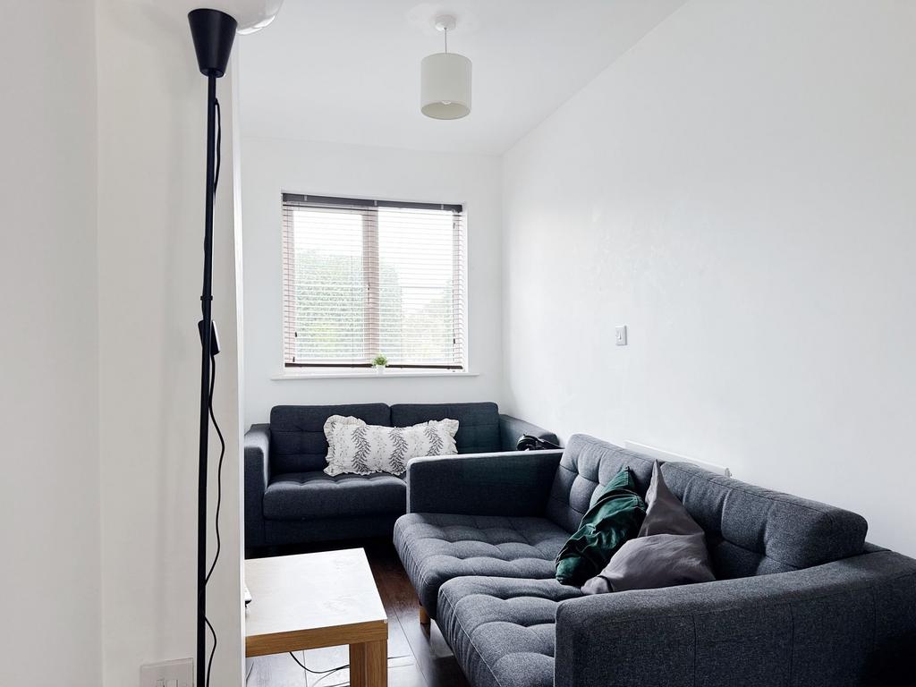 Bright, modern living room with two matching gr...