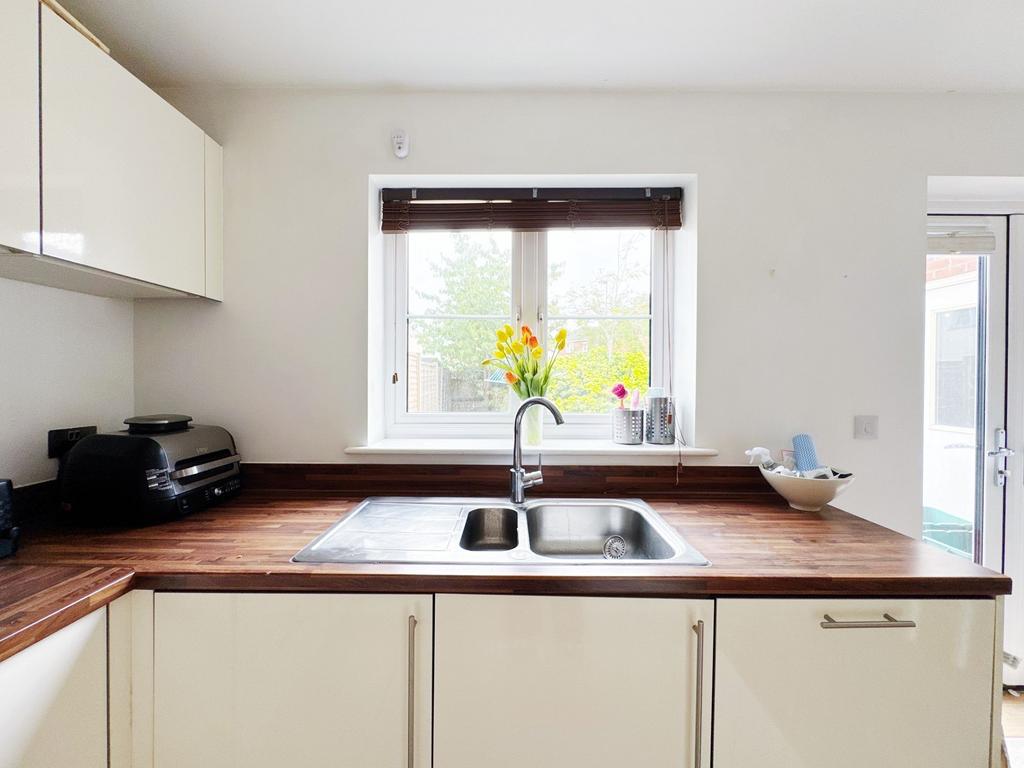 Bright modern kitchen with a double stainless-s...