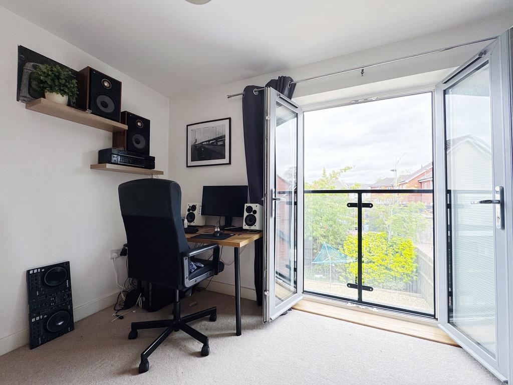 Bright, modern bedroom with a study corner and ...