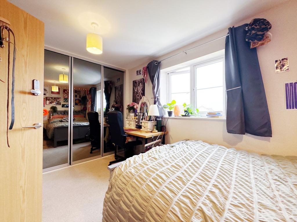 Bright, well-furnished bedroom with a large win...