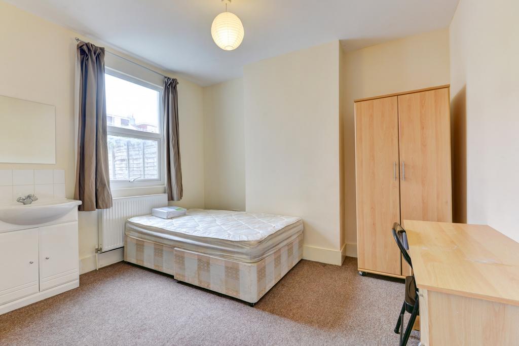 Bright and welcoming double bedroom featuring a...