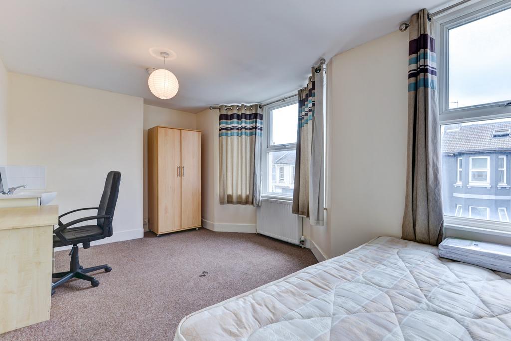 A bright and well-maintained bedroom featuring ...