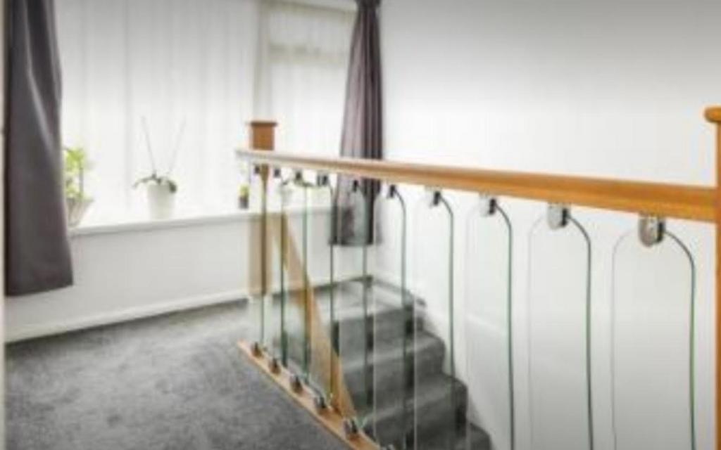 A bright and tidy hallway with elegant glass ra...