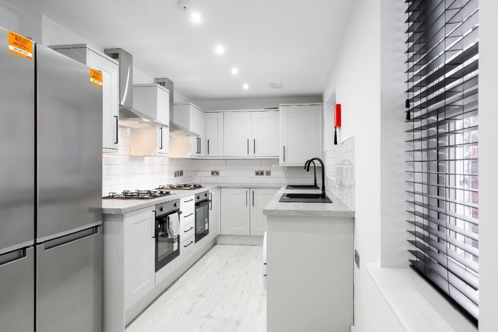 Modern kitchen featuring sleek cabinetry, ample...