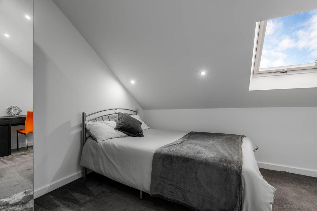 A well-maintained and cozy bedroom featuring a ...