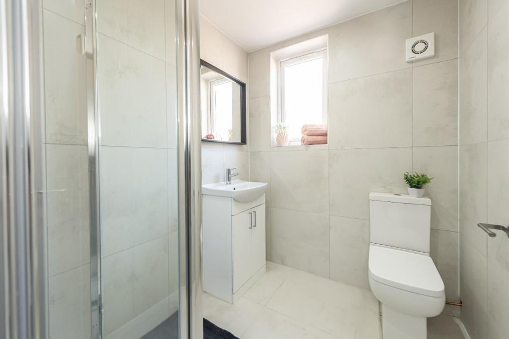 A modern and clean bathroom featuring a toilet,...