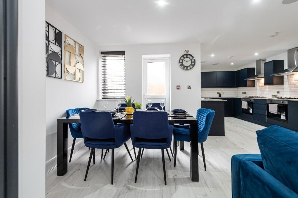 A bright and contemporary living room featuring...