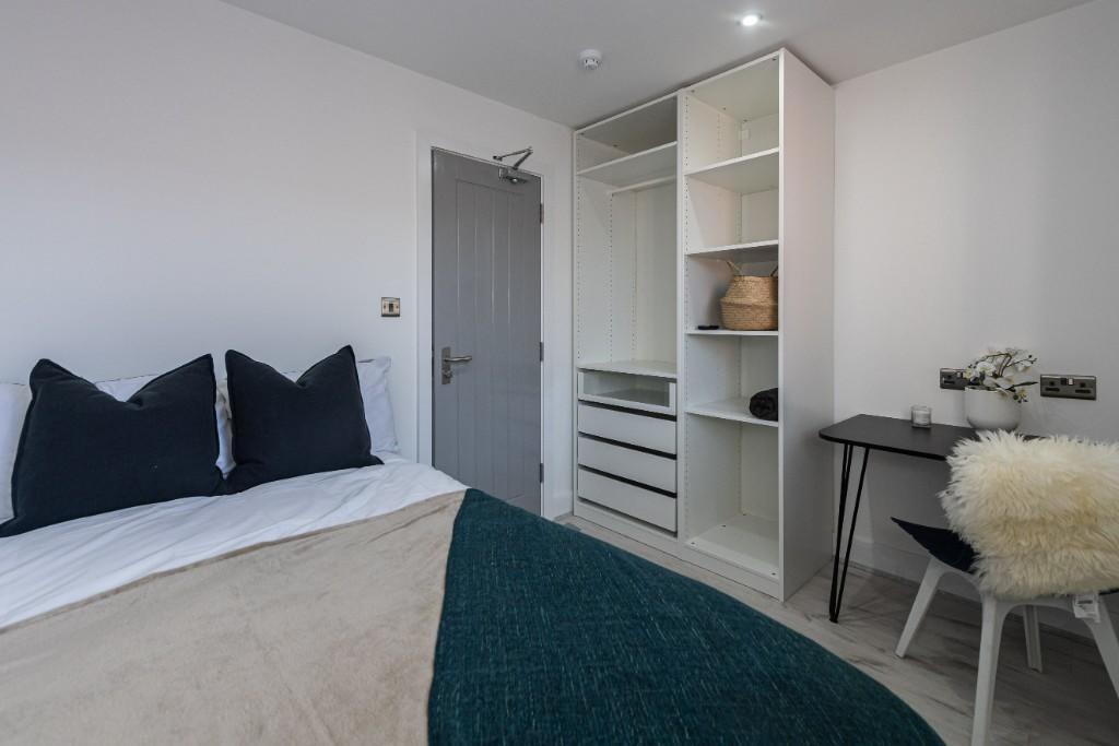 A cozy and well-maintained bedroom featuring a ...