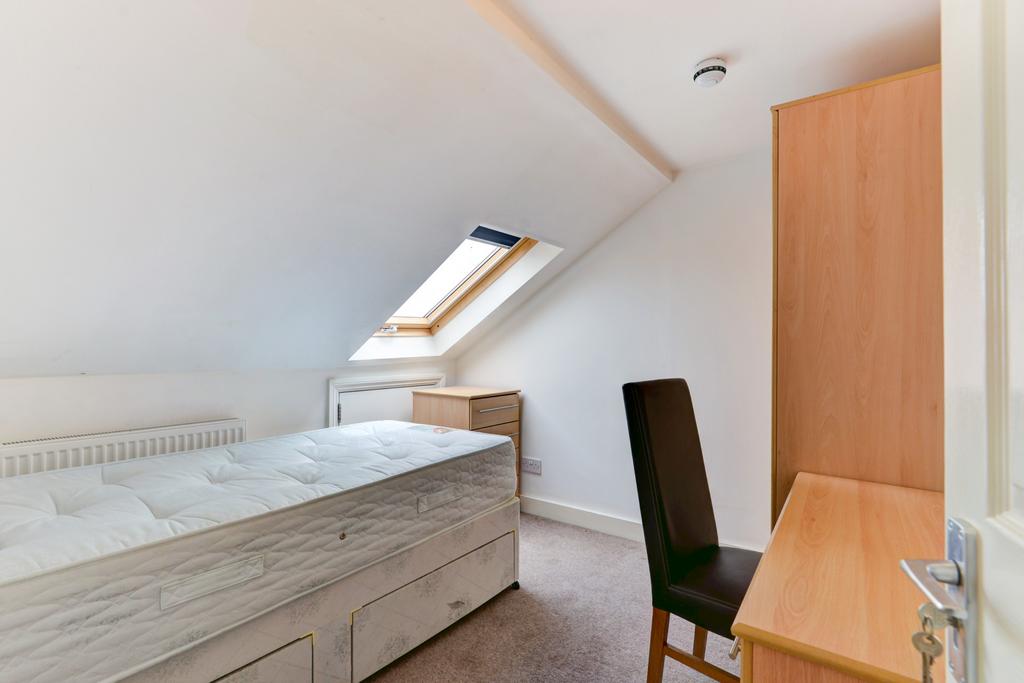 A bright and well-maintained bedroom featuring ...