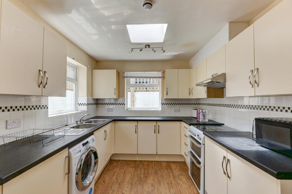 A bright, well-maintained kitchen featuring mod...