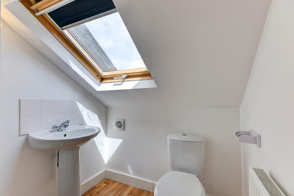 A bright and clean bathroom with a white toilet...