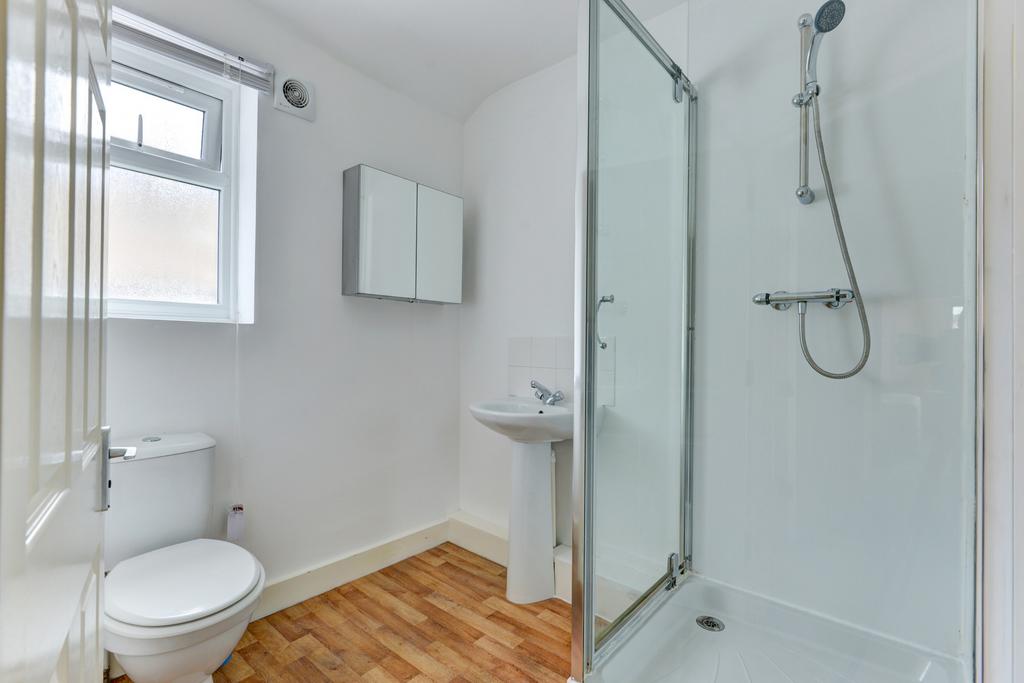 A clean and bright bathroom with a modern showe...