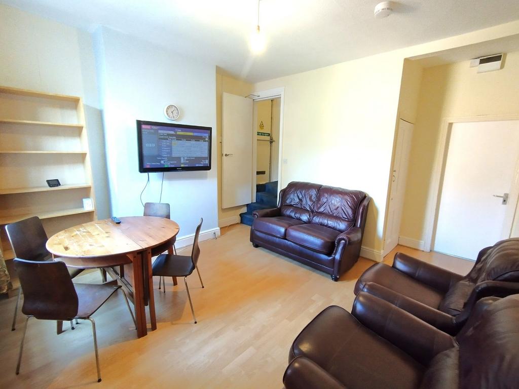 Bright, well-furnished living room with leather...