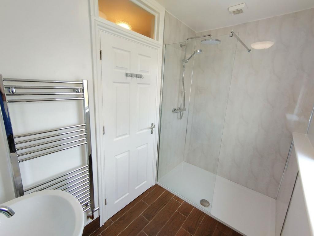 Bright, modern bathroom with a large walk-in sh...