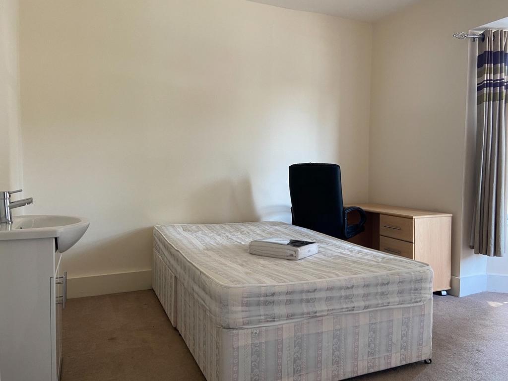 A small, tidy room featuring a toilet and minim...