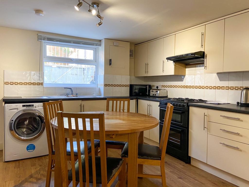 Bright, well-equipped kitchen with a dining tab...