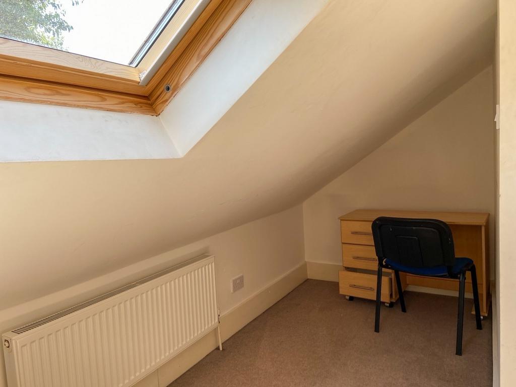 Cozy attic single bedroom with a skylight that ...