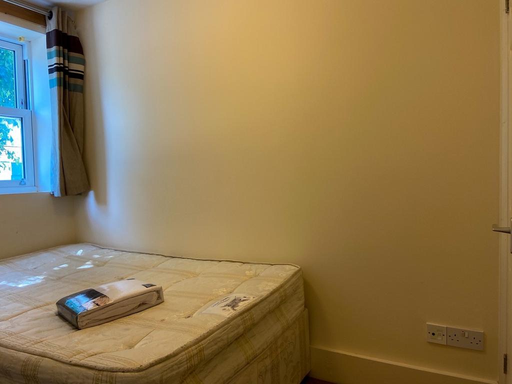 Compact bedroom with a mattress placed near a w...