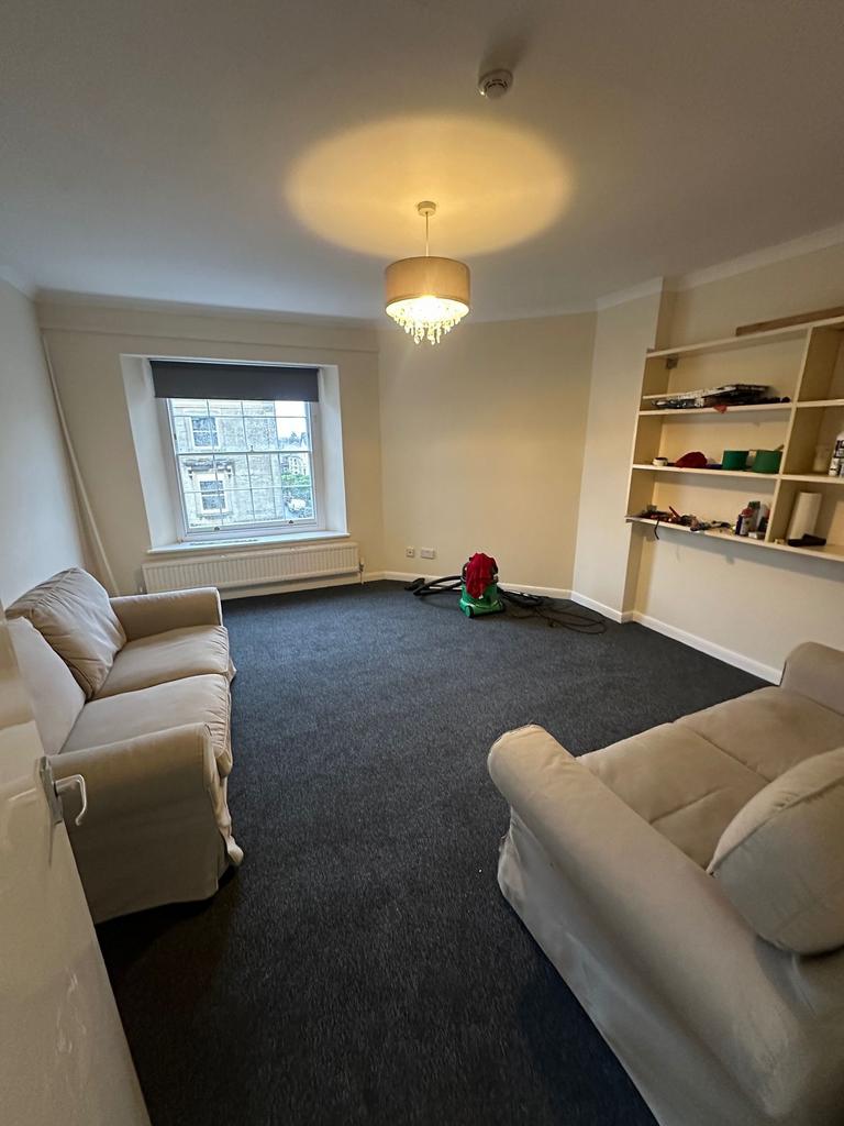 Bright, neutrally decorated living room with tw...