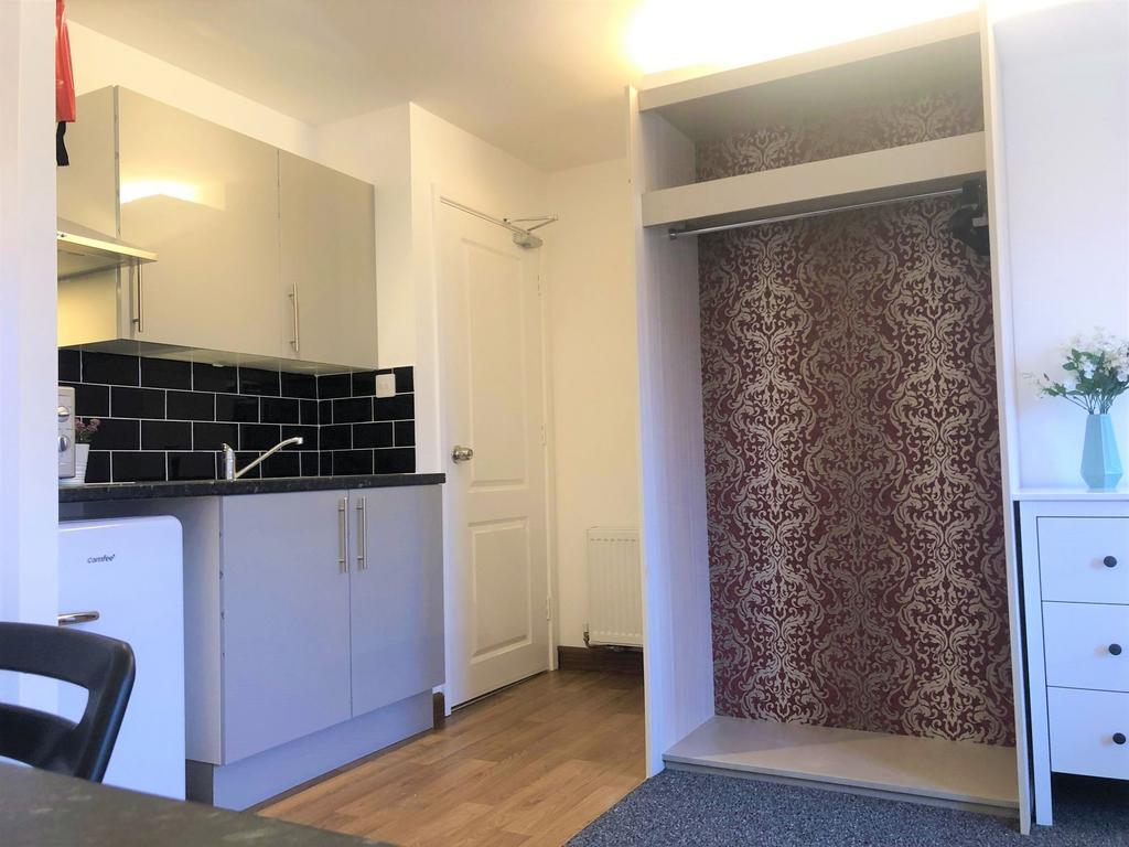 A clean and modern kitchenette featuring sleek ...