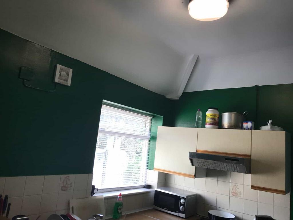 A functional kitchen with a window providing na...