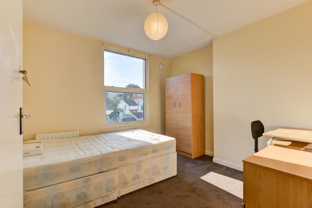 A bright and inviting single bedroom featuring ...