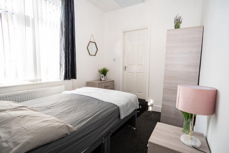 Bright, neatly presented bedroom with a comfort...