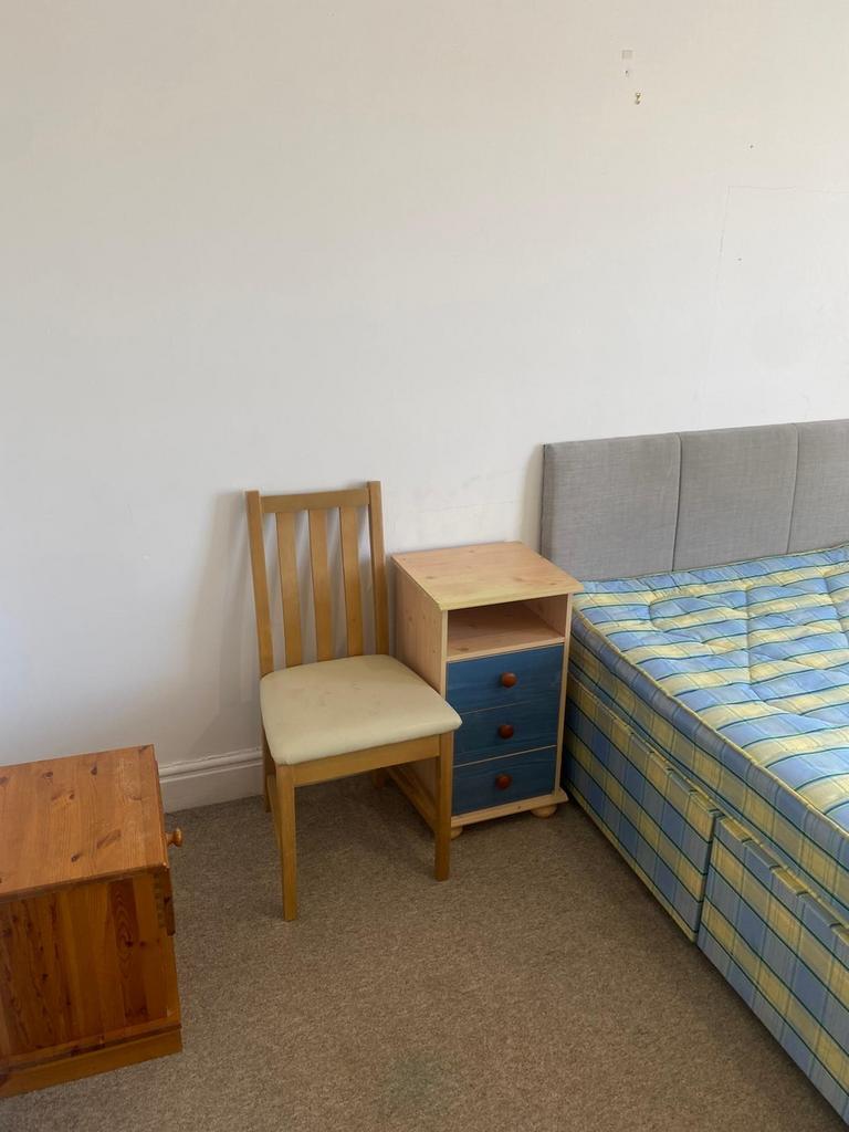 Simple furnished bedroom corner with a divan-st...