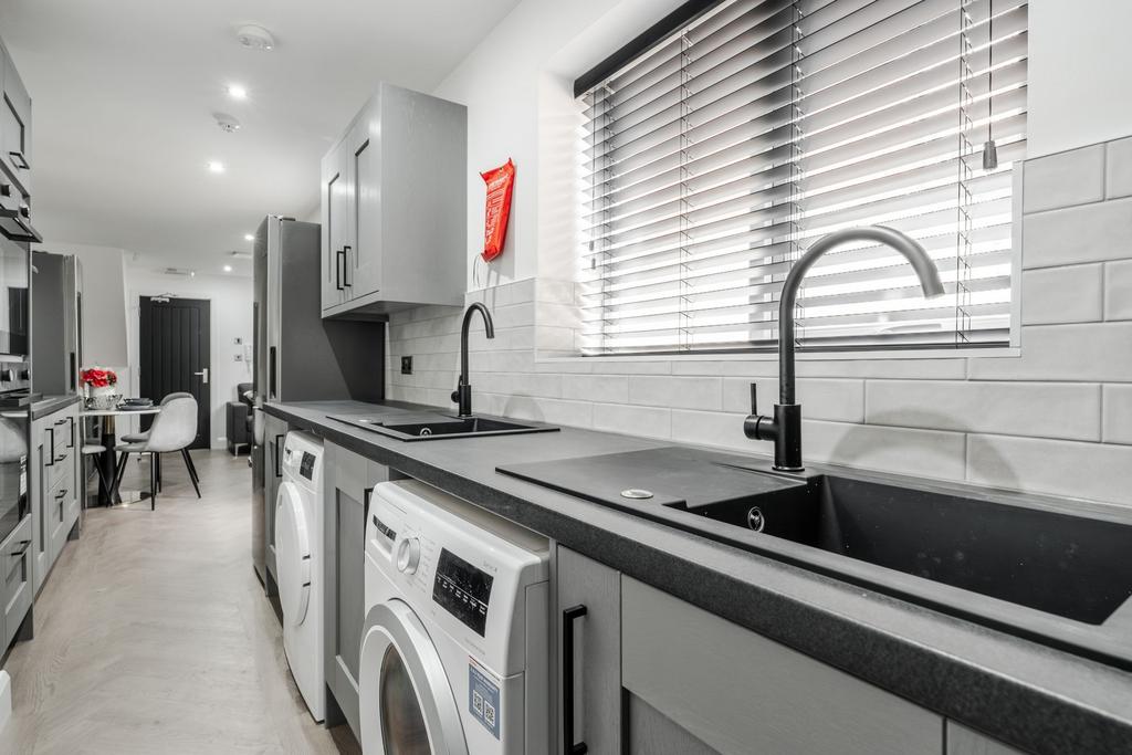 Modern, bright kitchen with sleek grey cabinetr...