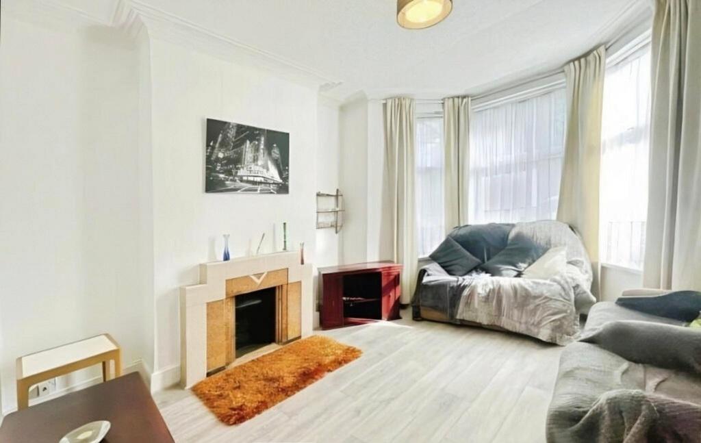 Bright, modern living room with large bay windo...