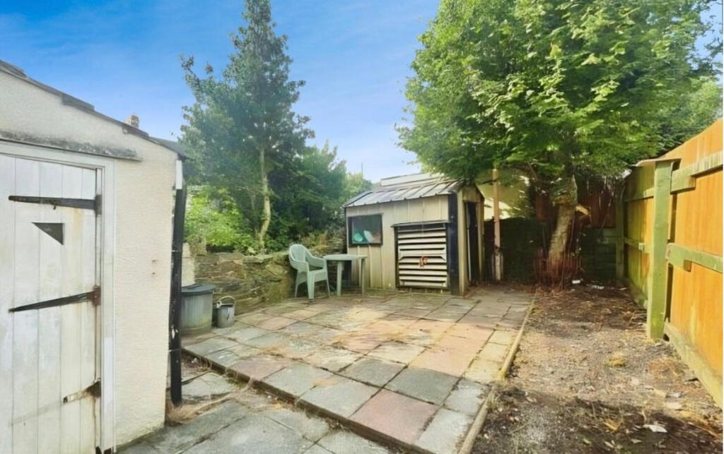Private rear garden with paved patio, mature tr...