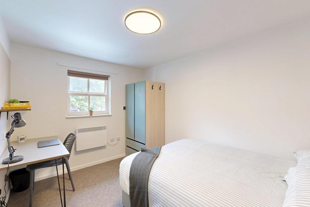 Bright, neatly presented bedroom with a comfort...