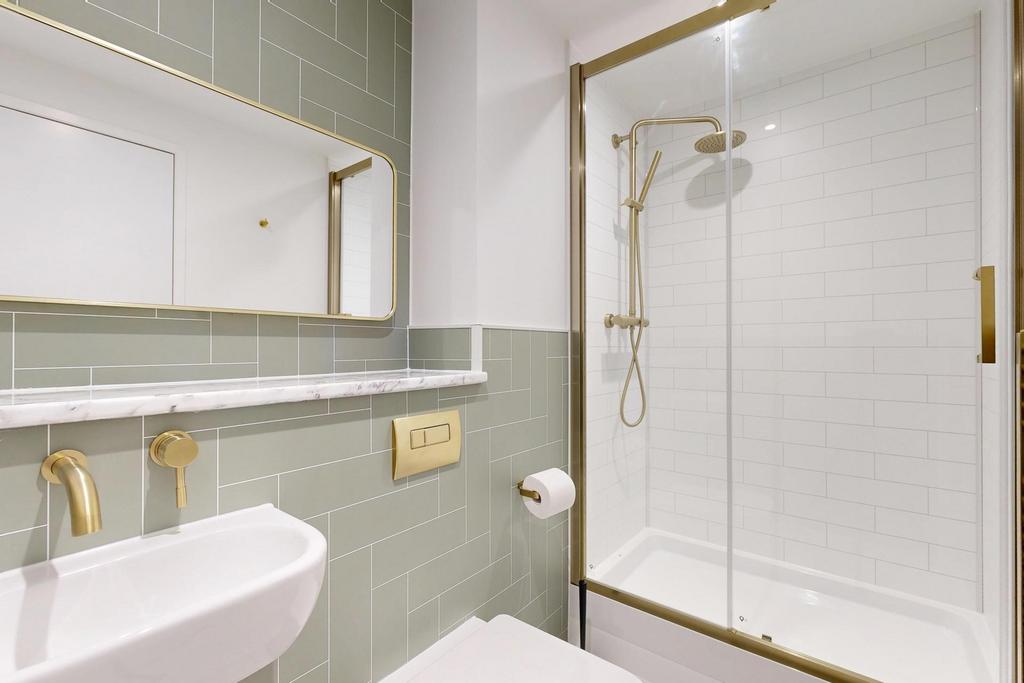 Modern bathroom suite with a glazed shower encl...