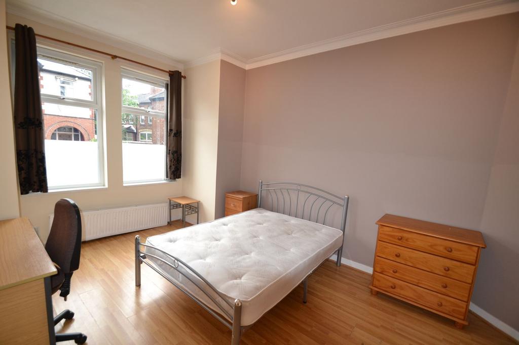 A clean and well-lit bedroom featuring two larg...