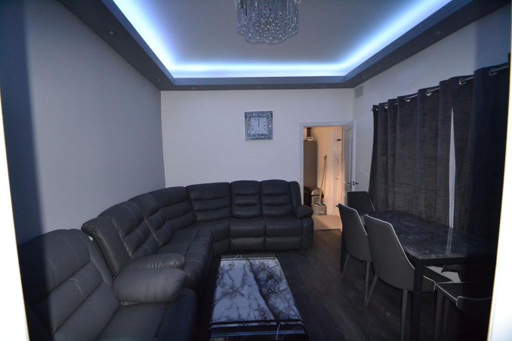Modern and spacious living room featuring a lar...