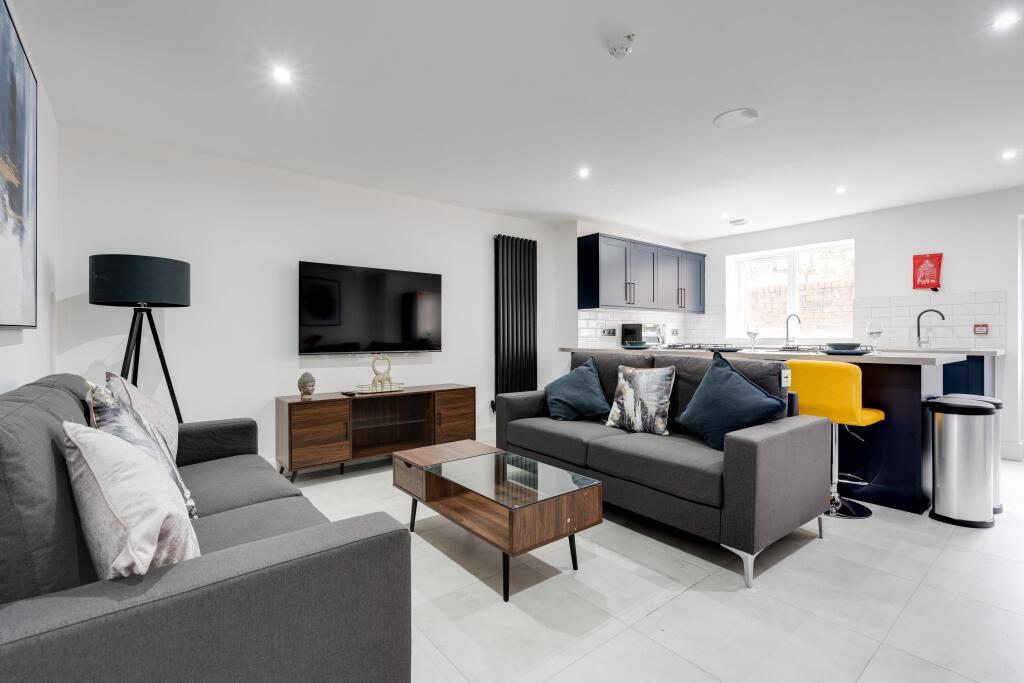 A modern and spacious living room with contempo...