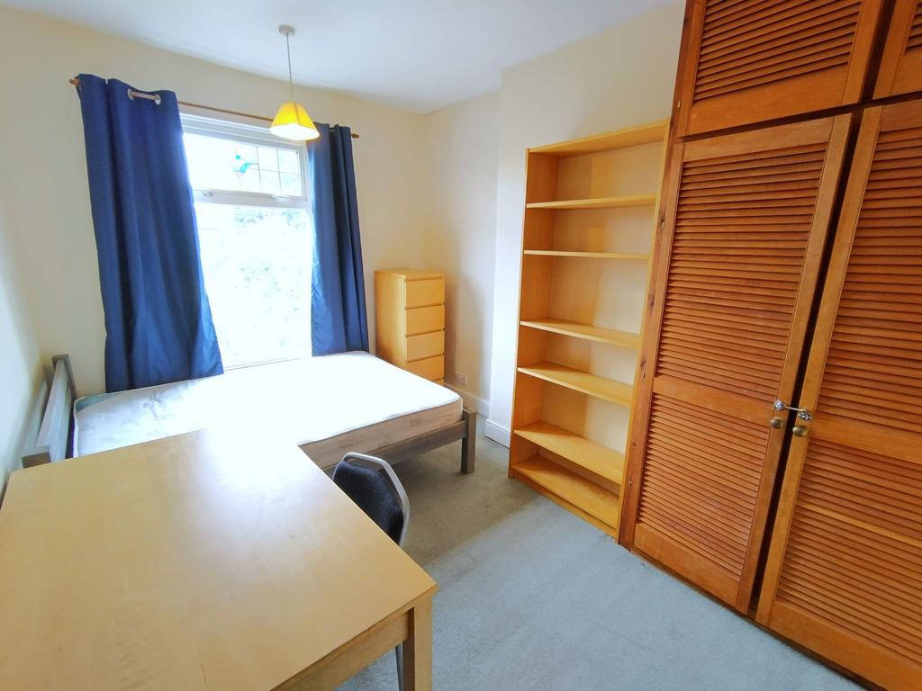 Bright, well-presented bedroom with a large win...