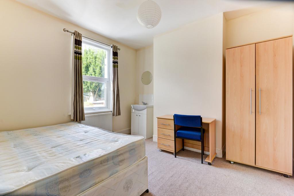 Bright and welcoming master bedroom featuring a...