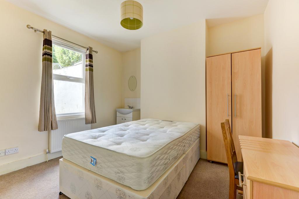 Bright, simply furnished double bedroom with a ...